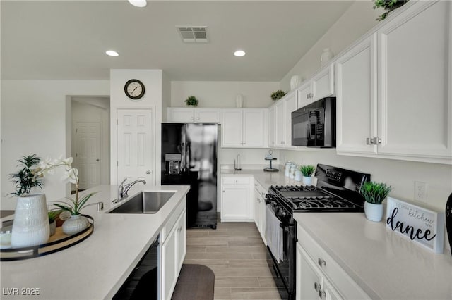 10345 Zebra Swallowtail St, Las Vegas, NV 89141 - kitchen with black appliances, a sink, white cabinets, light countertops, and recessed lighting