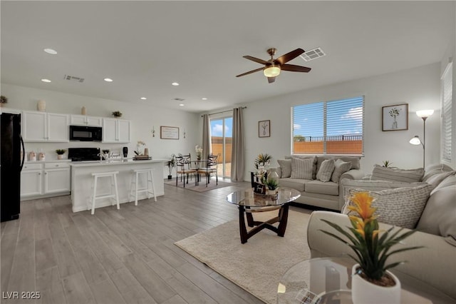10345 Zebra Swallowtail St, Las Vegas, NV 89141 - living room featuring healthy amount of natural light, light wood-type flooring, a ceiling fan, and recessed lighting