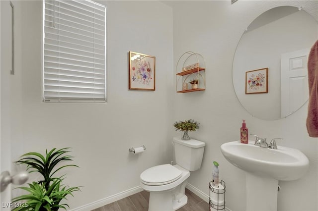 10345 Zebra Swallowtail St, Las Vegas, NV 89141 - bathroom with toilet, baseboards, wood finished floors, and a sink