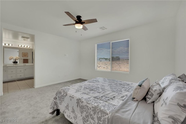10345 Zebra Swallowtail St, Las Vegas, NV 89141 - bedroom featuring light carpet, connected bathroom, ceiling fan, baseboards, and light tile patterned floors
