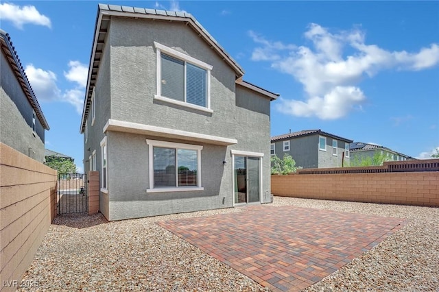 10345 Zebra Swallowtail St, Las Vegas, NV 89141 - rear view of property with stucco siding, a gate, a fenced backyard, and a patio area