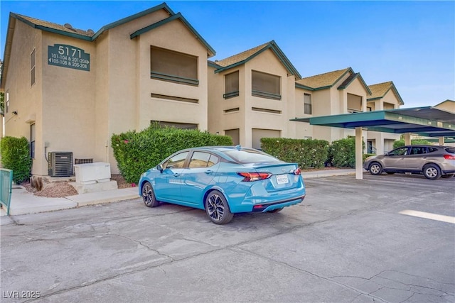 5171 Lindell Rd Unit 201, Las Vegas, NV 89118 - view of property featuring covered and uncovered parking and central AC