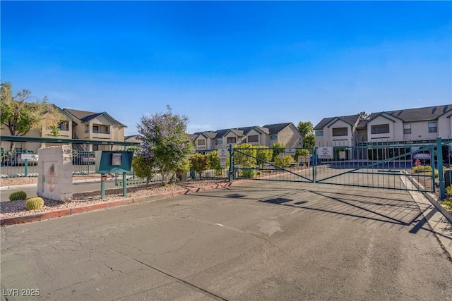 5171 Lindell Rd Unit 201, Las Vegas, NV 89118 - view of asphalt street with a residential view, a gated entry, a gate, and curbs