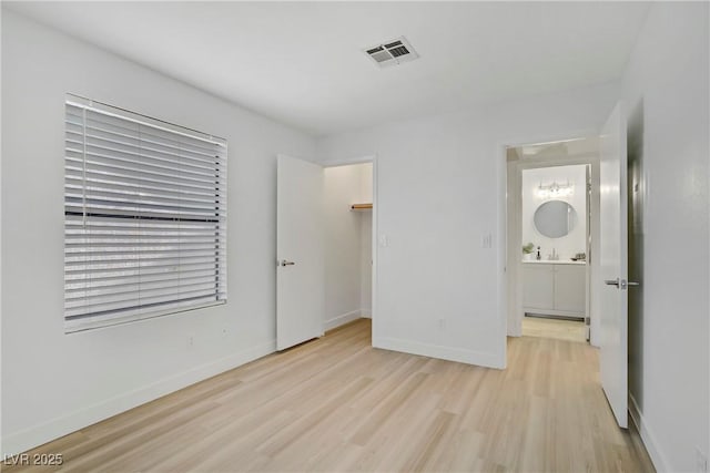 5171 Lindell Rd Unit 201, Las Vegas, NV 89118 - unfurnished bedroom featuring light wood-type flooring, baseboards, and a sink