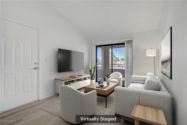 5171 Lindell Rd Unit 201, Las Vegas, NV 89118 - living area featuring lofted ceiling, light wood-style flooring, and baseboards