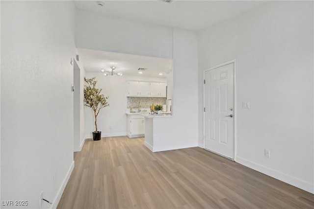 5171 Lindell Rd Unit 201, Las Vegas, NV 89118 - unfurnished living room with light wood-style flooring and baseboards