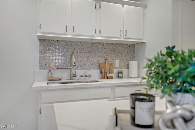 5171 Lindell Rd Unit 201, Las Vegas, NV 89118 - kitchen with a sink, light countertops, white cabinets, and backsplash