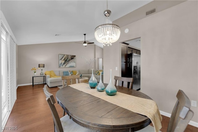2701 Glencliff Dr, Las Vegas, NV 89134 - dining space featuring a chandelier, wood finished floors, lofted ceiling, baseboards, and a ceiling fan