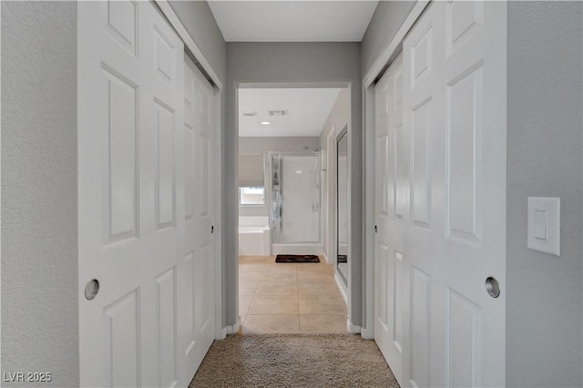 405 Prairie Moon Ave, North Las Vegas, NV 89084 - hallway featuring light tile patterned floors, light carpet, and baseboards