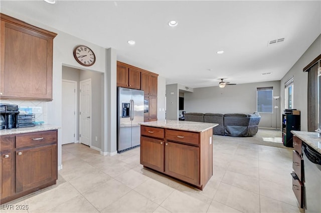 405 Prairie Moon Ave, North Las Vegas, NV 89084 - kitchen with appliances with stainless steel finishes, ceiling fan, a kitchen island, open floor plan, and light tile patterned floors