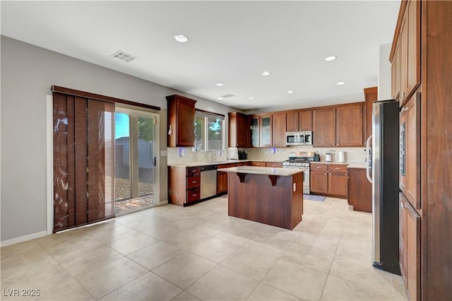 405 Prairie Moon Ave, North Las Vegas, NV 89084 - kitchen featuring stainless steel appliances, a kitchen island, a kitchen bar, decorative backsplash, and recessed lighting
