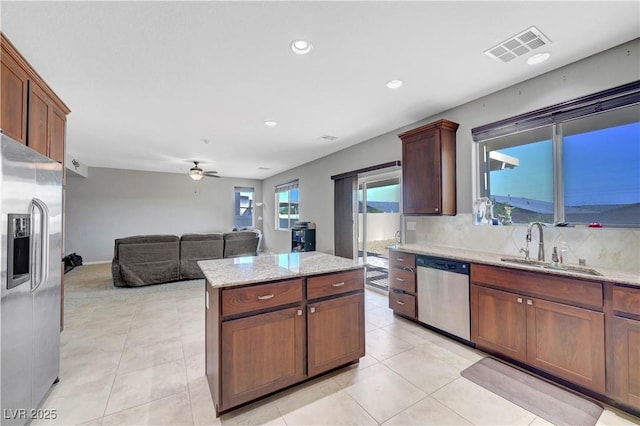 405 Prairie Moon Ave, North Las Vegas, NV 89084 - kitchen with stainless steel appliances, ceiling fan, a sink, tasteful backsplash, and recessed lighting