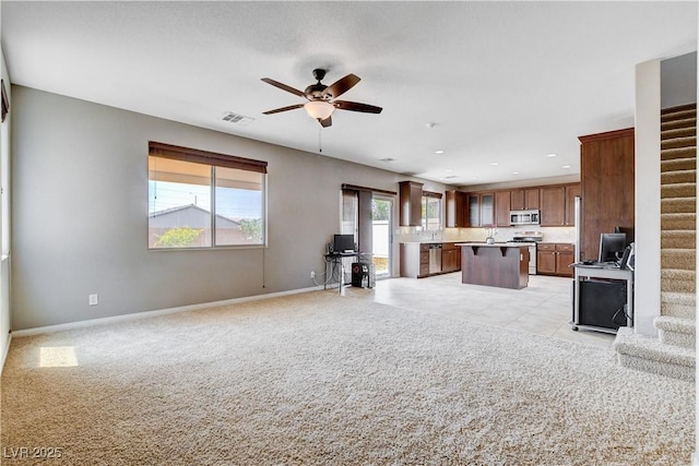 405 Prairie Moon Ave, North Las Vegas, NV 89084 - unfurnished living room with stairs, a ceiling fan, light carpet, and recessed lighting