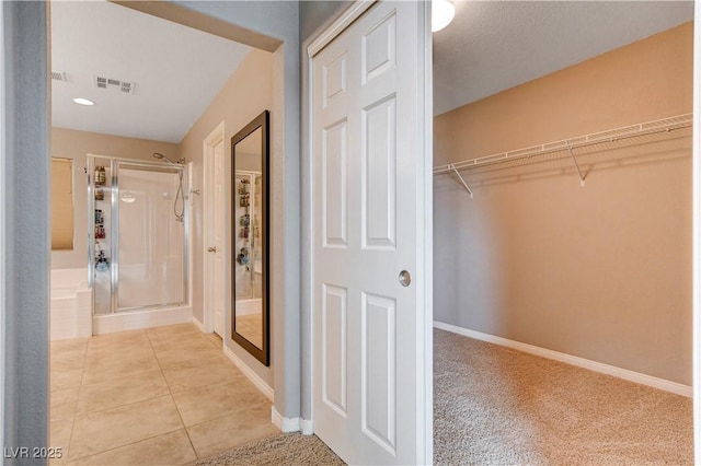 405 Prairie Moon Ave, North Las Vegas, NV 89084 - bathroom with a stall shower, a walk in closet, and tile patterned floors