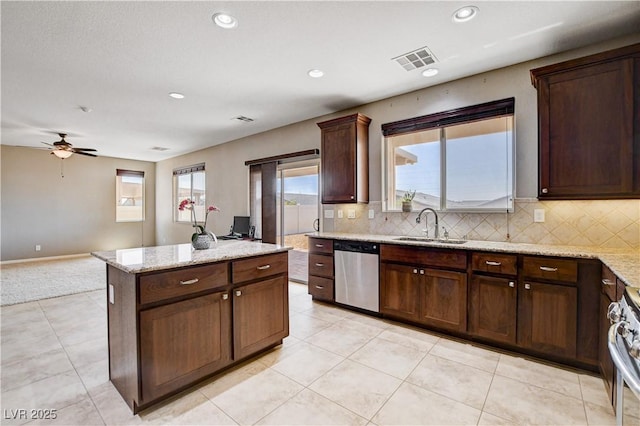 405 Prairie Moon Ave, North Las Vegas, NV 89084 - kitchen with stainless steel dishwasher, a kitchen island, decorative backsplash, range, and recessed lighting