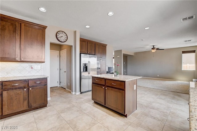 405 Prairie Moon Ave, North Las Vegas, NV 89084 - kitchen featuring stainless steel fridge, ceiling fan, open floor plan, tasteful backsplash, and a kitchen island