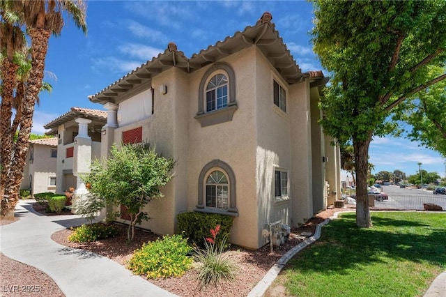 3420 Winterhaven St Unit 202, Las Vegas, NV 89108 - view of home's exterior with stucco siding and a yard