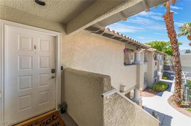 3420 Winterhaven St Unit 202, Las Vegas, NV 89108 - doorway to property with stucco siding and a tiled roof