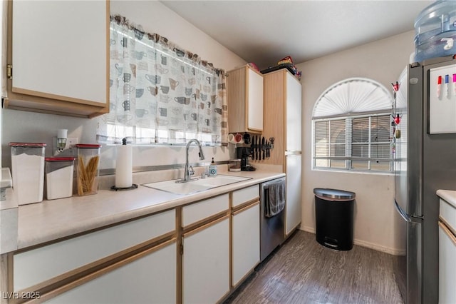 3420 Winterhaven St Unit 202, Las Vegas, NV 89108 - kitchen with a sink, stainless steel appliances, light countertops, wood finished floors, and white cabinets