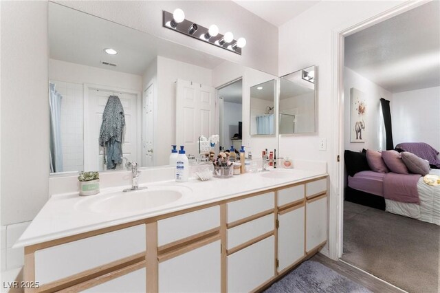 3420 Winterhaven St Unit 202, Las Vegas, NV 89108 - ensuite bathroom with double vanity and a shower with shower curtain