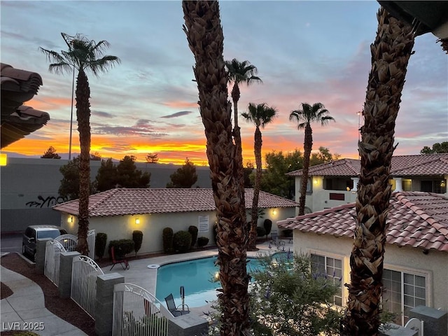 3420 Winterhaven St Unit 202, Las Vegas, NV 89108 - pool at dusk with an outdoor pool, a patio area, and a gate