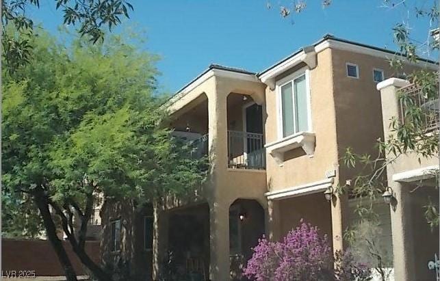 6927 Smiling Cloud Ave, Henderson, NV 89011 - view of property exterior featuring stucco siding and a balcony