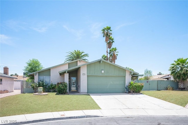 4409 Rosebank Cir, Las Vegas, NV 89108 - mid-century modern home with an attached garage, concrete driveway, a gate, board and batten siding, and stucco siding