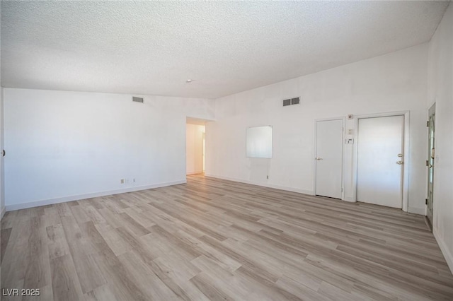 4409 Rosebank Cir, Las Vegas, NV 89108 - empty room featuring a textured ceiling, light wood-type flooring, and baseboards