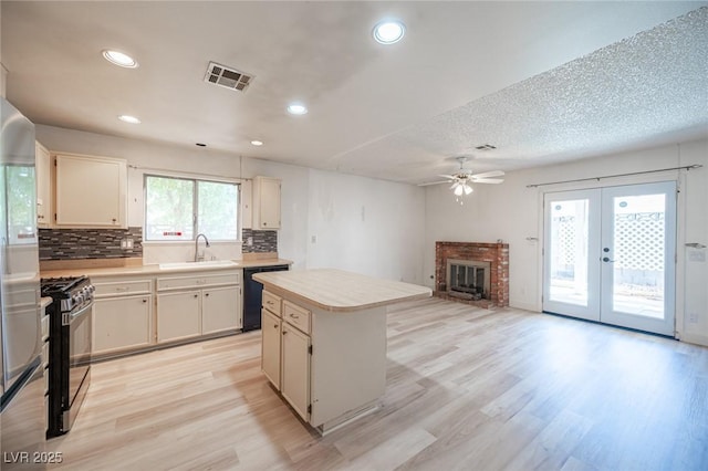 4409 Rosebank Cir, Las Vegas, NV 89108 - kitchen featuring black appliances, a sink, a ceiling fan, light countertops, and light wood-style flooring