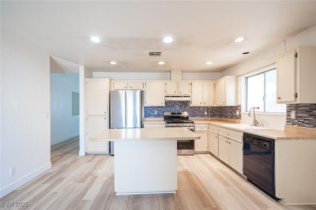4409 Rosebank Cir, Las Vegas, NV 89108 - kitchen featuring appliances with stainless steel finishes, a sink, under cabinet range hood, light countertops, and recessed lighting