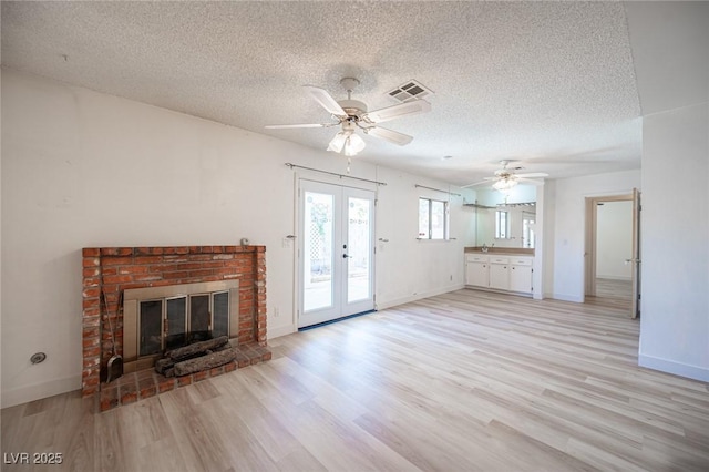 4409 Rosebank Cir, Las Vegas, NV 89108 - unfurnished living room featuring french doors, a textured ceiling, light wood-type flooring, a ceiling fan, and baseboards