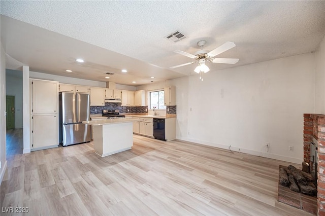 4409 Rosebank Cir, Las Vegas, NV 89108 - kitchen featuring appliances with stainless steel finishes, under cabinet range hood, light wood-style floors, light countertops, and recessed lighting