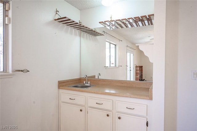 4409 Rosebank Cir, Las Vegas, NV 89108 - bathroom featuring a textured ceiling and vanity