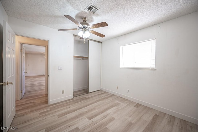 4409 Rosebank Cir, Las Vegas, NV 89108 - unfurnished bedroom featuring light wood-style floors, a closet, a textured ceiling, baseboards, and a ceiling fan