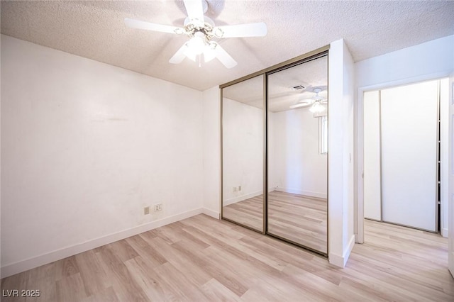 4409 Rosebank Cir, Las Vegas, NV 89108 - unfurnished bedroom with light wood-style floors, a textured ceiling, a closet, a ceiling fan, and baseboards