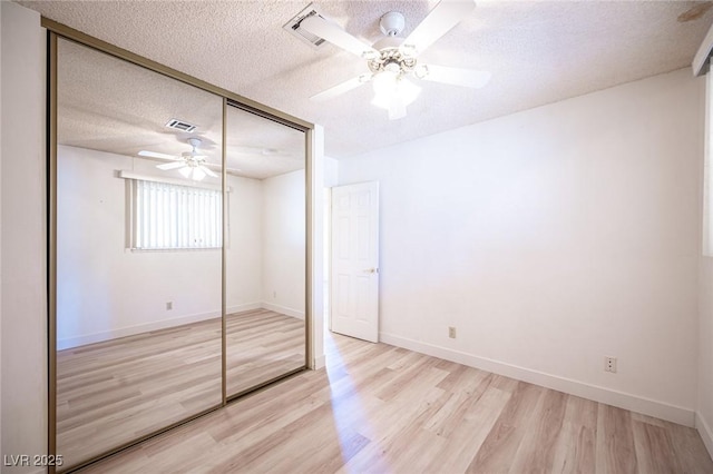 4409 Rosebank Cir, Las Vegas, NV 89108 - unfurnished bedroom with a closet, light wood-type flooring, a textured ceiling, baseboards, and a ceiling fan
