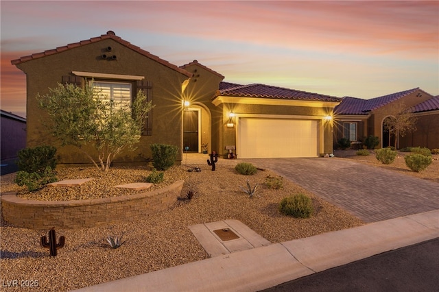 977 Majestic Vw, Mesquite, NV 89034 - mediterranean / spanish-style house featuring a tile roof, decorative driveway, an attached garage, and stucco siding