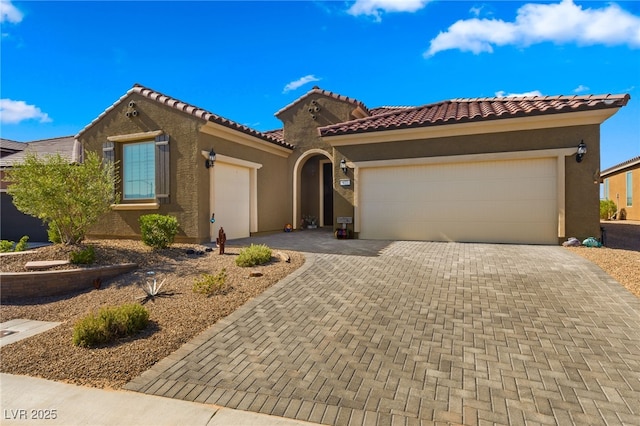 977 Majestic Vw, Mesquite, NV 89034 - view of front facade featuring an attached garage, stucco siding, decorative driveway, and a tiled roof