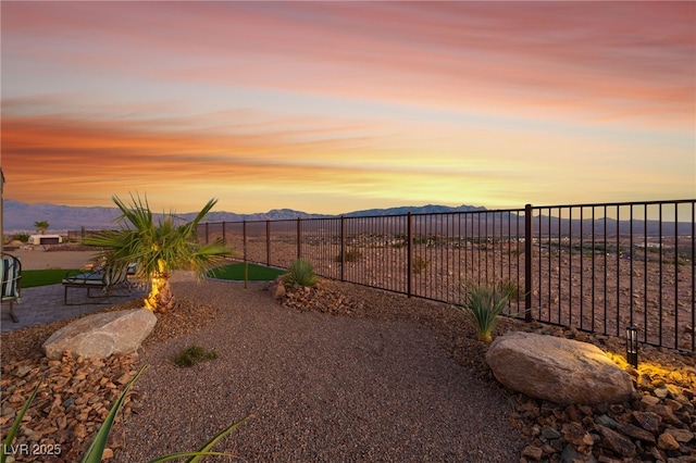 977 Majestic Vw, Mesquite, NV 89034 - yard at dusk with a mountain view and a fenced backyard