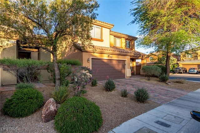 6954 Jacksboro Ct, North Las Vegas, NV 89084 - mediterranean / spanish home featuring a garage, driveway, stucco siding, and a tiled roof