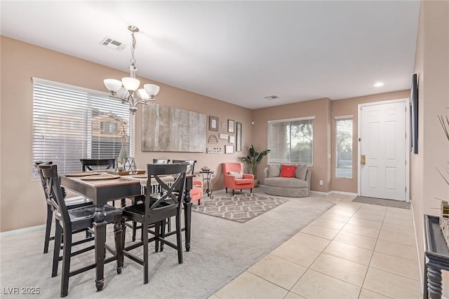 6954 Jacksboro Ct, North Las Vegas, NV 89084 - dining room featuring a chandelier, light colored carpet, baseboards, and light tile patterned flooring