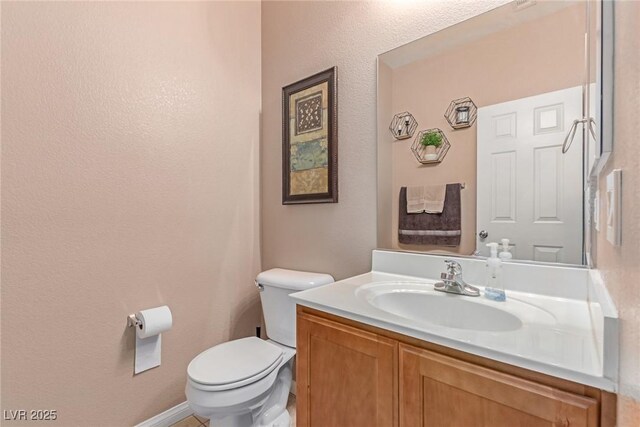 6954 Jacksboro Ct, North Las Vegas, NV 89084 - bathroom featuring toilet, vanity, and baseboards