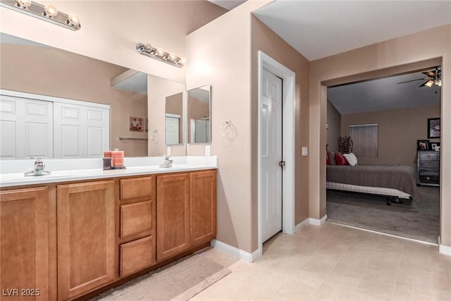 6954 Jacksboro Ct, North Las Vegas, NV 89084 - full bath featuring double vanity, ensuite bathroom, baseboards, and ceiling fan