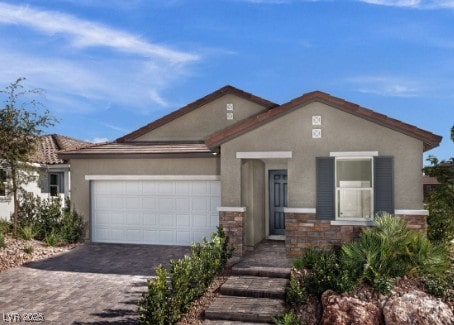 737 Wild Highlands Ln, Henderson, NV 89015 - view of front of house with an attached garage, decorative driveway, stone siding, and stucco siding