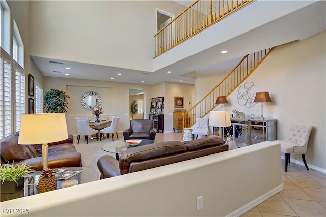6440 Bristlebird St, North Las Vegas, NV 89084 - tiled living area featuring a high ceiling, stairway, baseboards, and recessed lighting