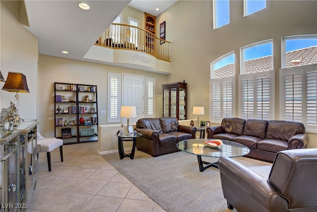 6440 Bristlebird St, North Las Vegas, NV 89084 - living room with light tile patterned flooring, healthy amount of natural light, a towering ceiling, baseboards, and recessed lighting