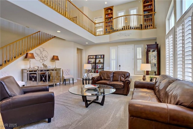 6440 Bristlebird St, North Las Vegas, NV 89084 - living room featuring a towering ceiling, stairway, baseboards, and recessed lighting