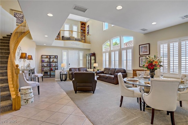 6440 Bristlebird St, North Las Vegas, NV 89084 - dining area featuring light carpet, light tile patterned flooring, stairway, recessed lighting, and a high ceiling