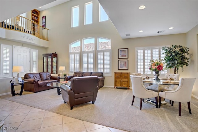 6440 Bristlebird St, North Las Vegas, NV 89084 - living area featuring light carpet, baseboards, light tile patterned floors, recessed lighting, and a towering ceiling