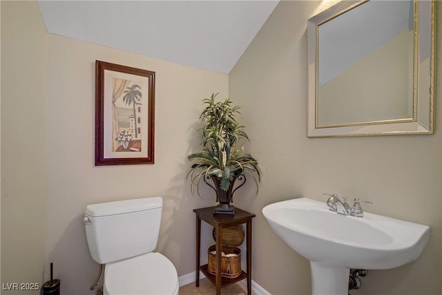 6440 Bristlebird St, North Las Vegas, NV 89084 - half bathroom with toilet, a sink, lofted ceiling, and baseboards